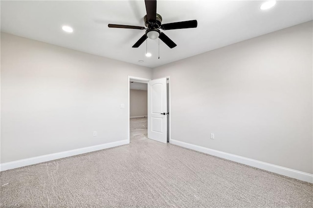 spare room with a ceiling fan, baseboards, recessed lighting, and light colored carpet