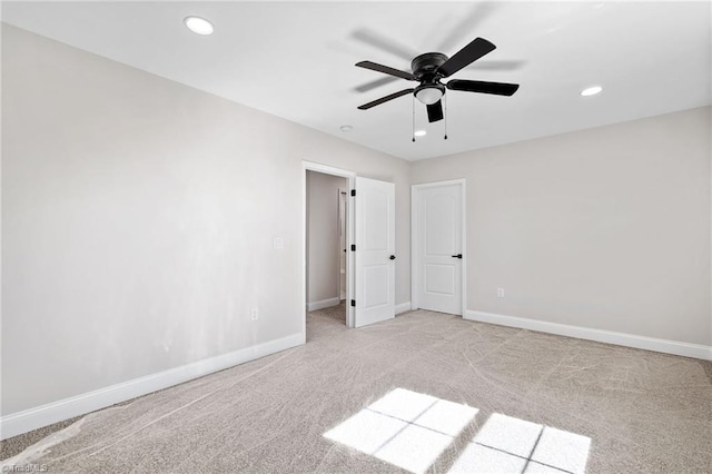 empty room featuring ceiling fan, baseboards, recessed lighting, and light colored carpet