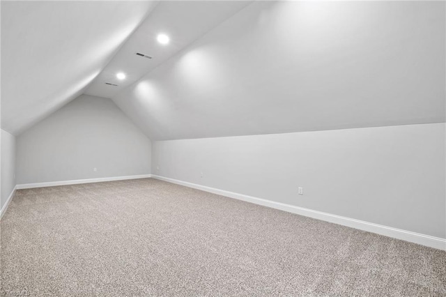 bonus room featuring recessed lighting, lofted ceiling, carpet floors, and baseboards