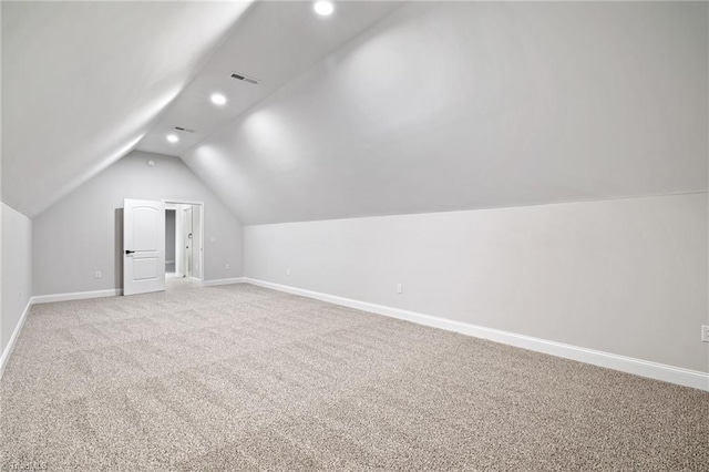 bonus room featuring baseboards, visible vents, recessed lighting, light colored carpet, and lofted ceiling