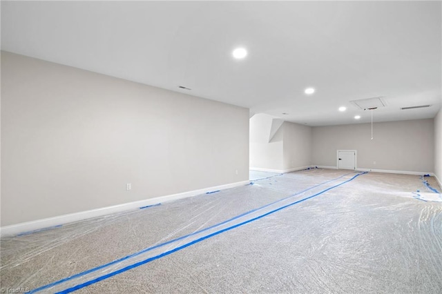 below grade area with baseboards and recessed lighting