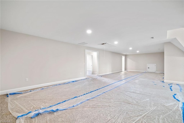 interior space with attic access, baseboards, and recessed lighting