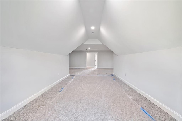 bonus room featuring lofted ceiling, carpet, baseboards, and recessed lighting