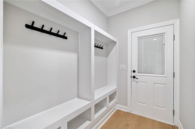 mudroom featuring light wood-type flooring, baseboards, and ornamental molding