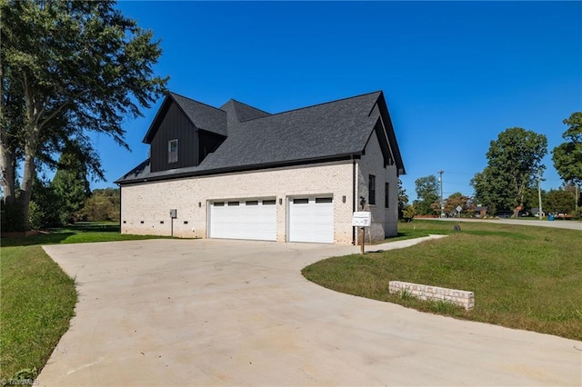 view of home's exterior featuring a lawn, brick siding, and concrete driveway