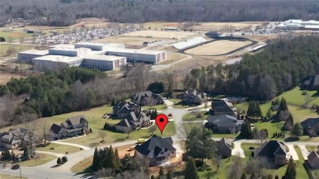 drone / aerial view with a wooded view