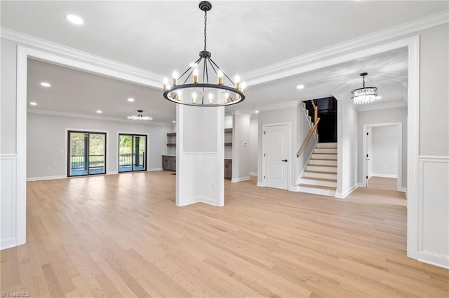 unfurnished dining area featuring stairway, a chandelier, light wood-type flooring, ornamental molding, and recessed lighting
