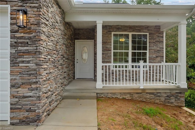 view of exterior entry with covered porch