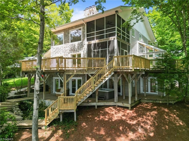 back of house with a wooden deck, a sunroom, and ceiling fan