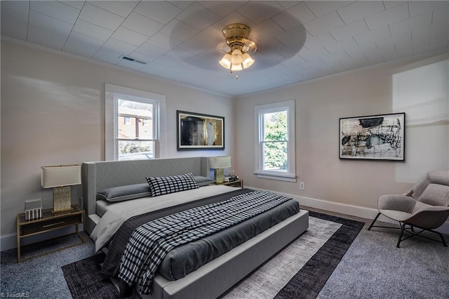 bedroom with ornamental molding, ceiling fan, and dark carpet