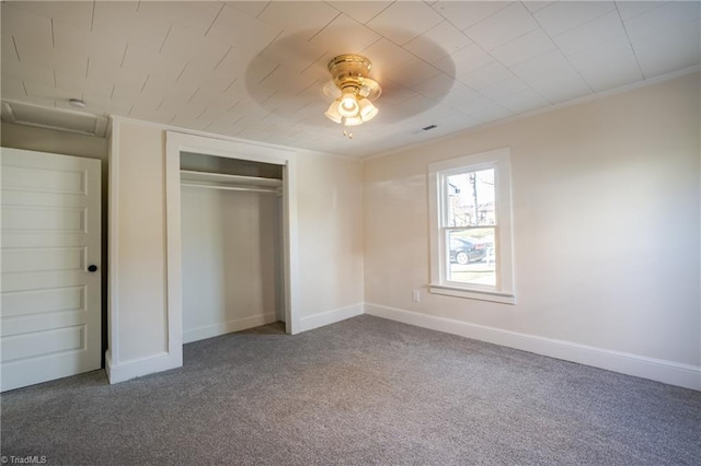 unfurnished bedroom featuring crown molding, ceiling fan, carpet flooring, and a closet