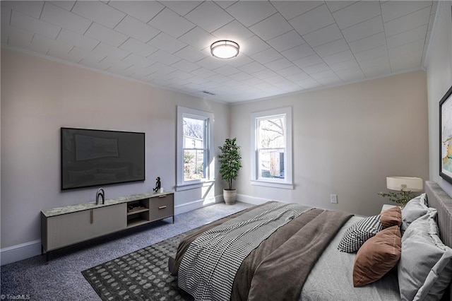 bedroom featuring ornamental molding and carpet