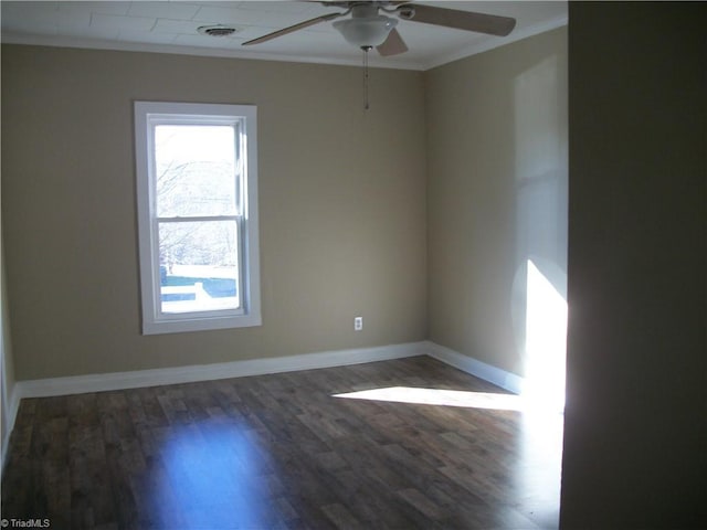 spare room featuring dark hardwood / wood-style floors, ceiling fan, and ornamental molding