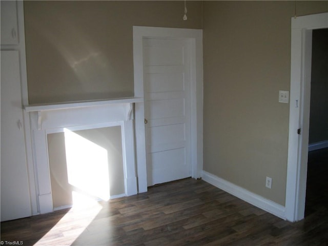 spare room with dark wood-type flooring