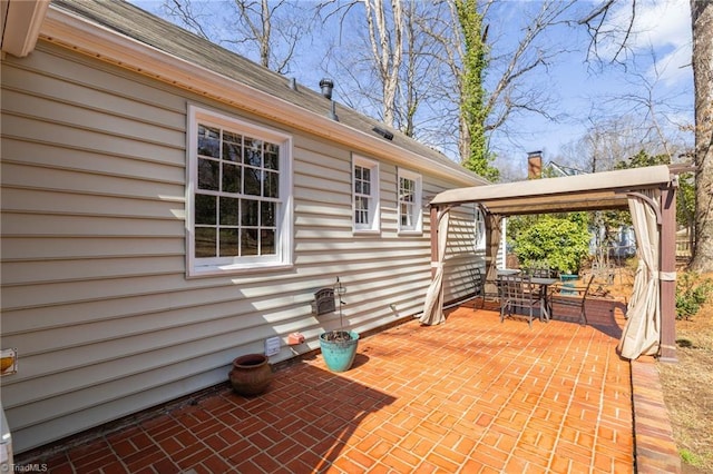 view of patio with a gazebo and outdoor dining area