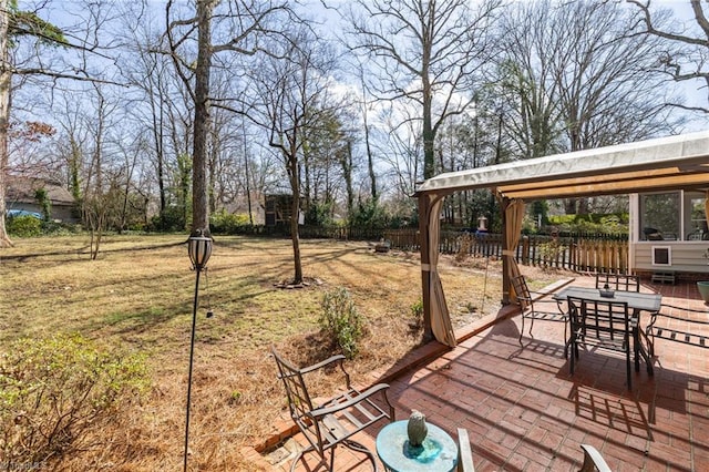 wooden terrace featuring a yard, a patio, and fence