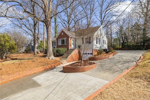 view of front facade featuring a garage, brick siding, and driveway