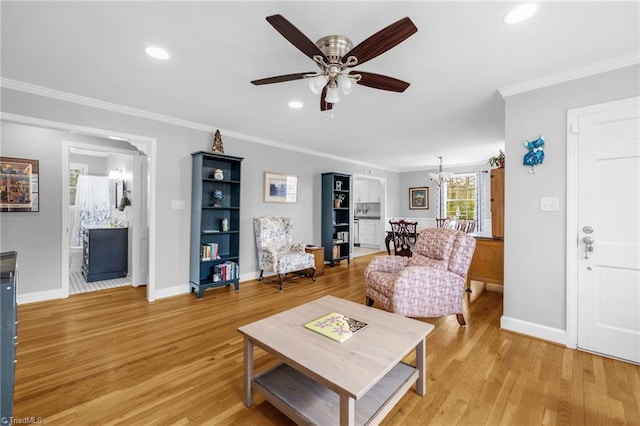 living room featuring ceiling fan with notable chandelier, recessed lighting, crown molding, light wood finished floors, and baseboards