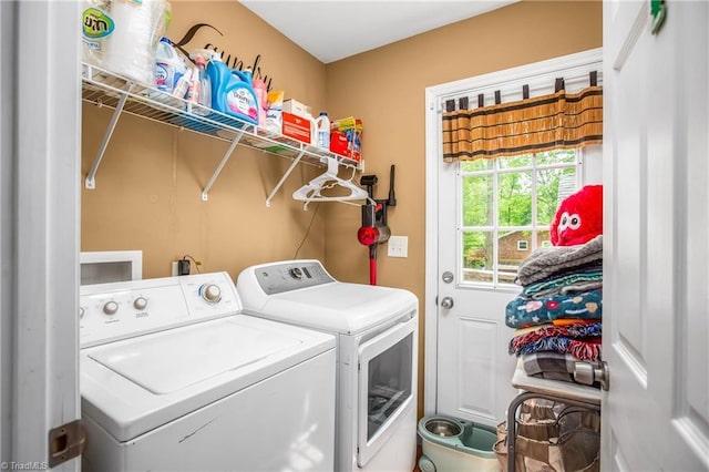 washroom with washing machine and clothes dryer and laundry area