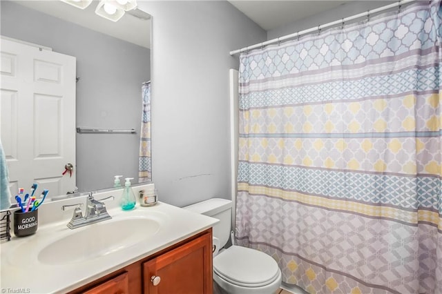 bathroom with vanity, toilet, and a shower with shower curtain