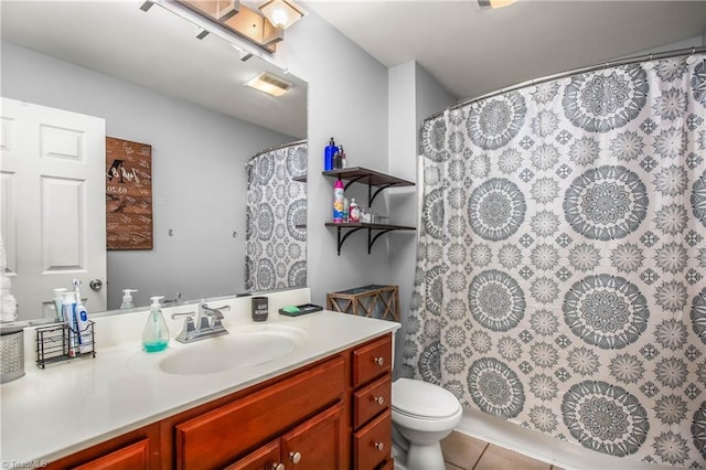 bathroom featuring toilet, curtained shower, tile patterned flooring, and vanity