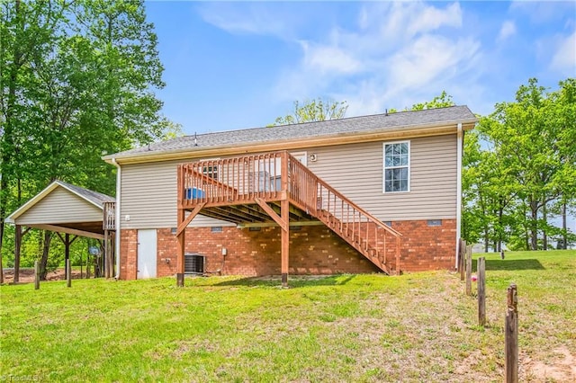 back of property featuring a deck, stairway, and a yard