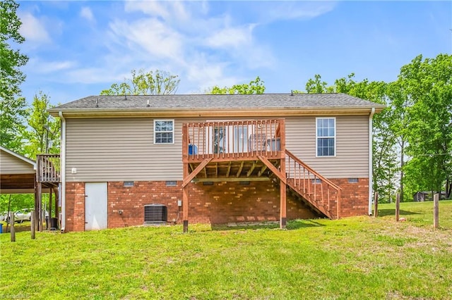 rear view of property featuring a lawn, a wooden deck, central air condition unit, and stairs
