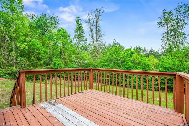 wooden terrace featuring a yard