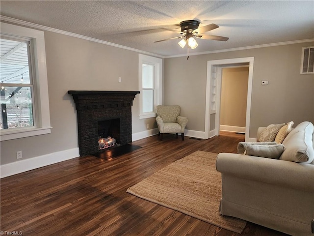 living room featuring a textured ceiling, a wealth of natural light, a fireplace, and dark hardwood / wood-style floors