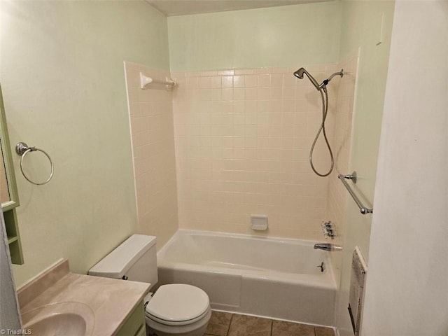 full bathroom with tile patterned flooring, vanity, tiled shower / bath combo, and toilet