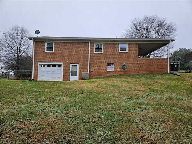 rear view of property with central AC unit, a garage, and a lawn