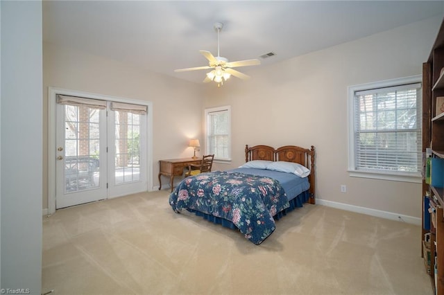 3913 Katie Dr, Greensboro, NC 27410 - carpeted bedroom featuring multiple windows, baseboards, visible vents, and access to exterior