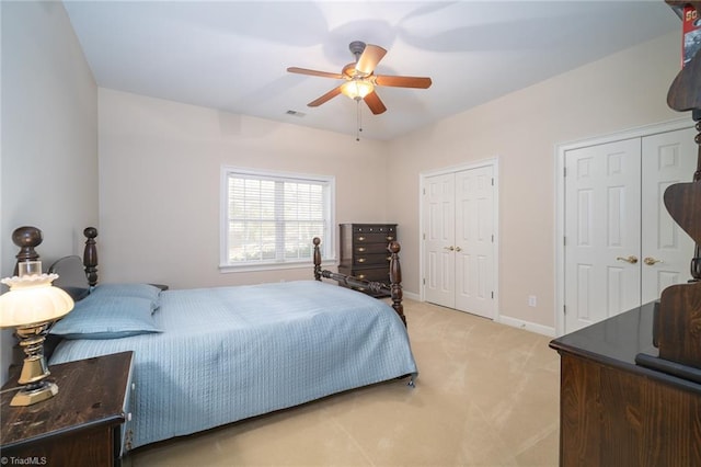 3913 Katie Dr, Greensboro, NC 27410 - bedroom with multiple closets, visible vents, baseboards, light colored carpet, and ceiling fan
