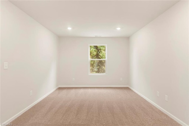 unfurnished room featuring light carpet