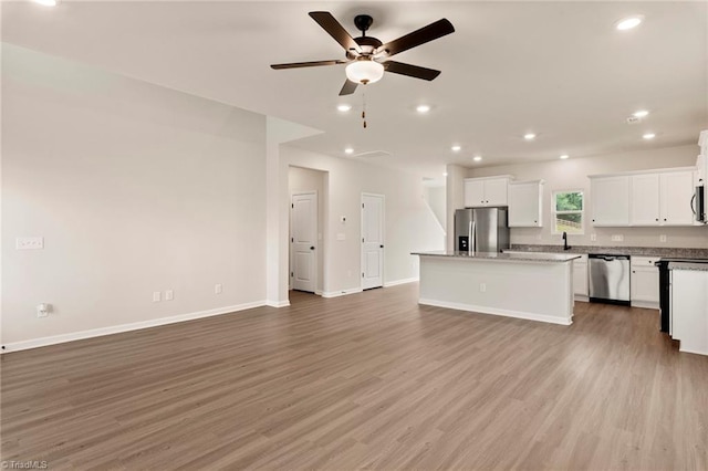 kitchen featuring a center island, ceiling fan, light wood-type flooring, white cabinetry, and stainless steel appliances