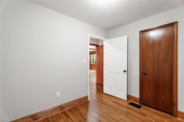 506 W 26th St, Winston-Salem, NC 27105 - unfurnished bedroom featuring baseboards and light wood-type flooring