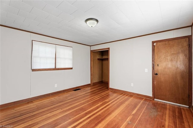 506 W 26th St, Winston-Salem, NC 27105 - unfurnished bedroom with ornamental molding, wood finished floors, and a closet