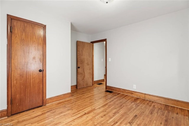 506 W 26th St, Winston-Salem, NC 27105 - unfurnished bedroom featuring baseboards and light wood finished floors