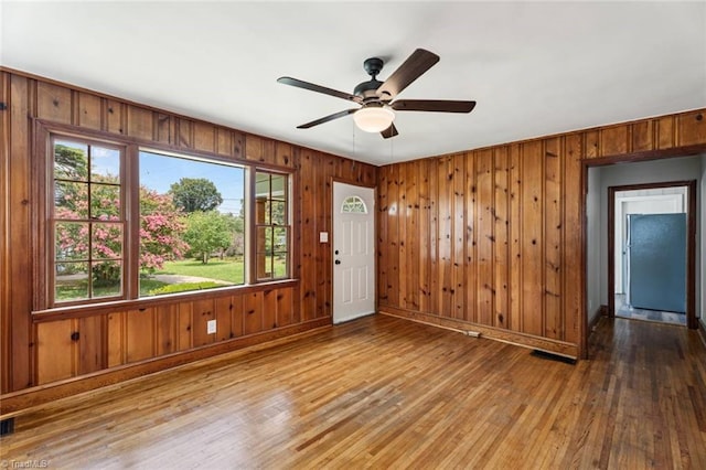 506 W 26th St, Winston-Salem, NC 27105 - spare room with wood finished floors, wooden walls, and a ceiling fan