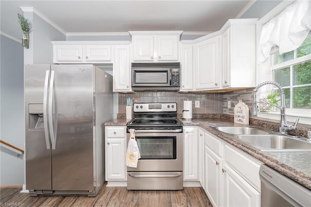 1029 Robbins St, Asheboro, NC 27203 - kitchen featuring stainless steel appliances, crown molding, white cabinets, and tasteful backsplash