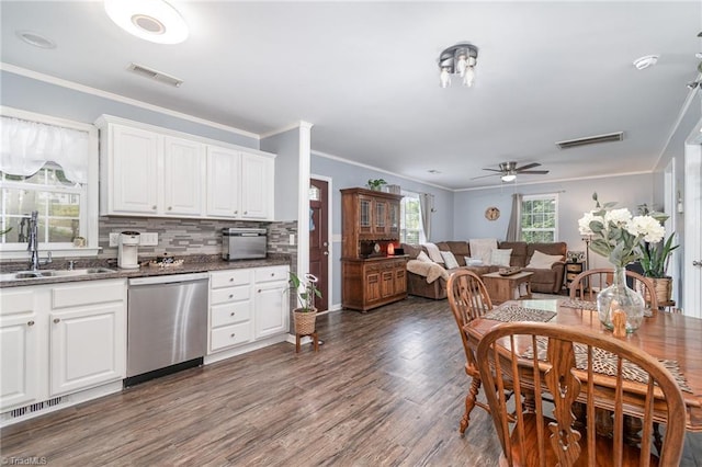 1029 Robbins St, Asheboro, NC 27203 - kitchen with stainless steel dishwasher, crown molding, dark wood-style floors, ceiling fan, and white cabinets