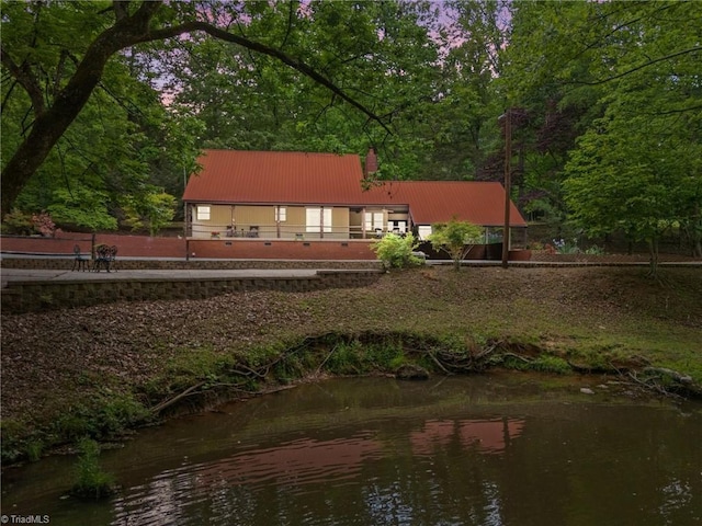 4701 Brock Dr, Hurdle Mills, NC 27541 - back of property featuring metal roof and a chimney