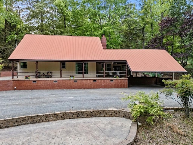 4701 Brock Dr, Hurdle Mills, NC 27541 - view of front of house featuring metal roof, driveway, a chimney, and a porch