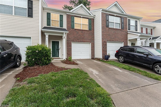 3840 Tarrant Trace Cir, High Point, NC 27265 - townhome / multi-family property featuring an attached garage, driveway, and brick siding
