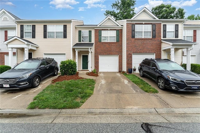 3840 Tarrant Trace Cir, High Point, NC 27265 - townhome / multi-family property featuring driveway, an attached garage, and brick siding