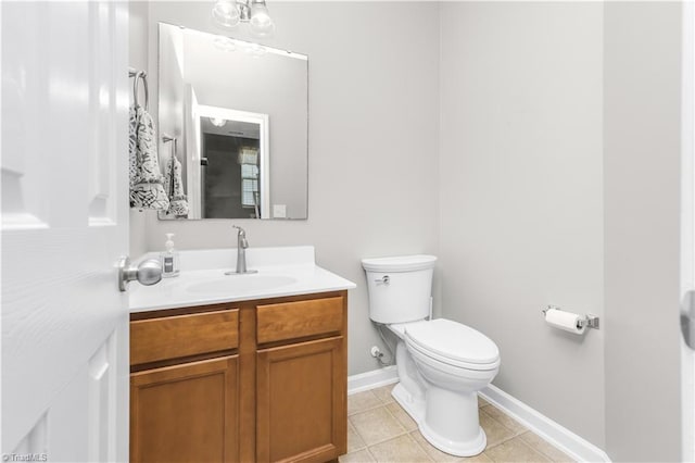 half bathroom with toilet, baseboards, vanity, and tile patterned floors