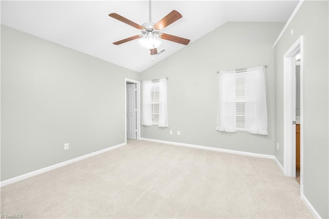 unfurnished room with light carpet, baseboards, and lofted ceiling