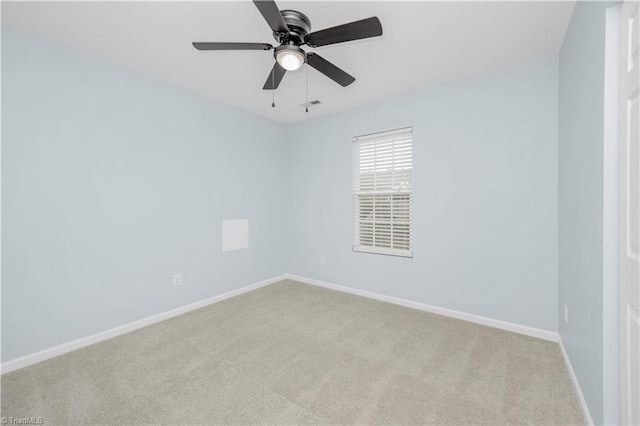 unfurnished room featuring light carpet, a ceiling fan, and baseboards