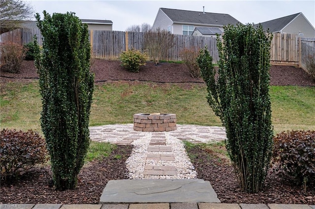 view of yard featuring a patio, an outdoor fire pit, and a fenced backyard