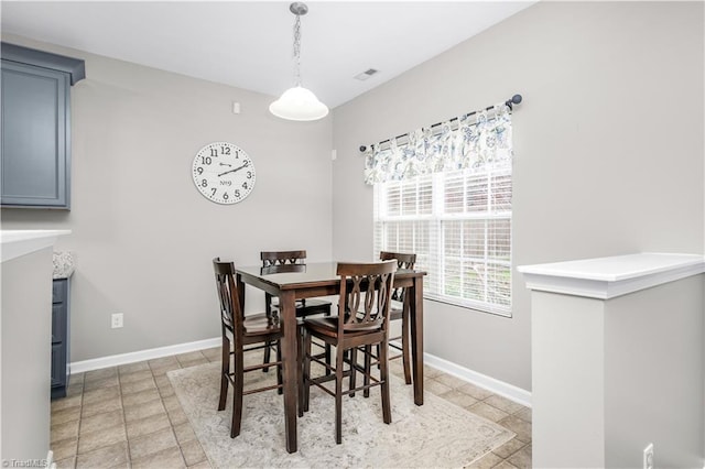 dining area with baseboards and light tile patterned floors